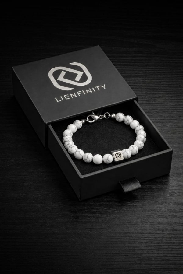 Bracelet LIENFINITY. en pierre naturelle Howlite blanche marbrée de gris , doté d'un insert en acier inoxydable 316L avec Signature QR code. Le bijou est présenté dans son écrin premium noir à tiroir.